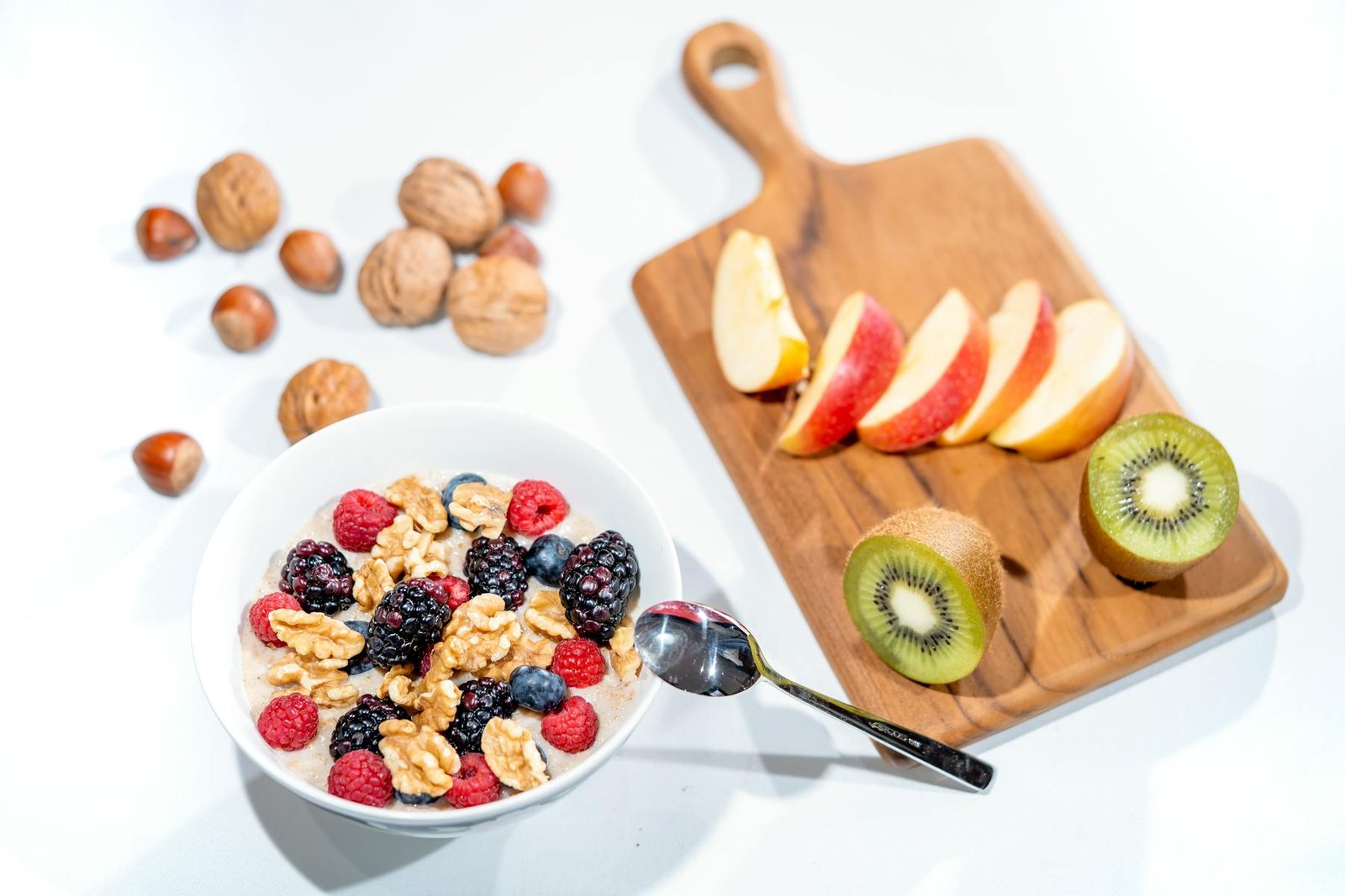 A bowl of berries, nuts, and breakfast grains